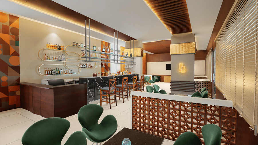 Citron Bar, the best place for dinner in Indore at Essentia Luxury Hotel, featuring seating arrangements under warm lighting and a bar counter