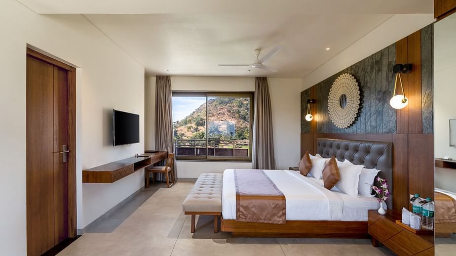 view of king size bed and TV of Suite at Stone Wood Hotel, Kumbhalgarh