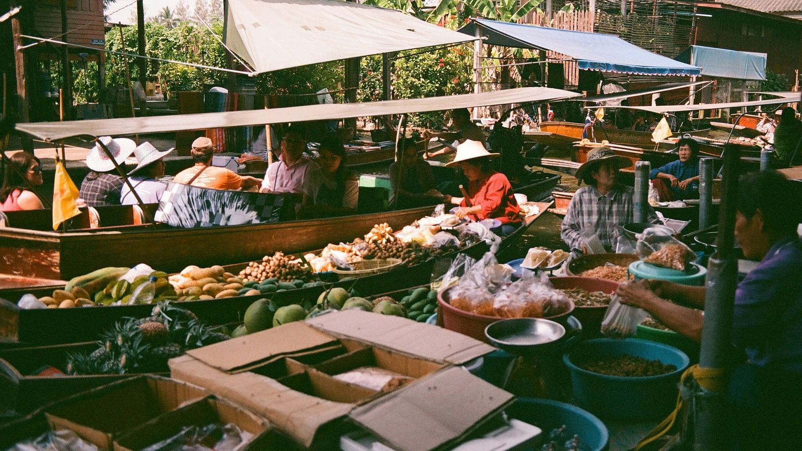 an overview of a floating market with people buying and selling different things