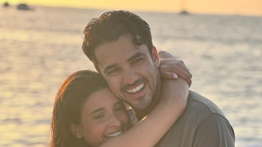 A happy couple embracing tightly on a pier at sunset at Casa Morada.