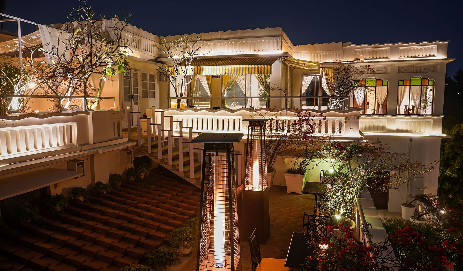 Exterior of well-lit Saraca Bar at Saraca Hotel, Lucknow at night