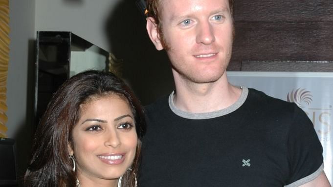a celebrity couple posing for a picture during the opening of IOSIS Spa & Wellness