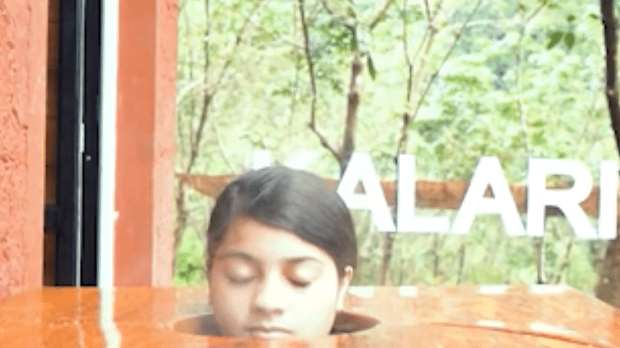 a girl sitting inside a steam box - Holistic Stay Eco Resort, Kannur