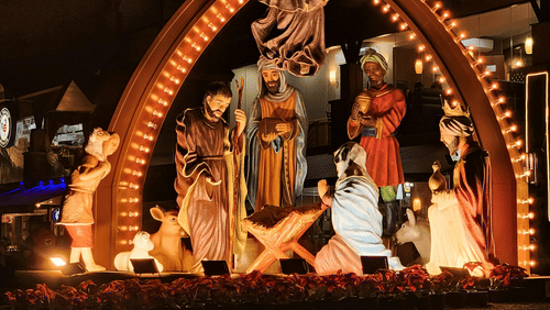 Vibrant Durga Puja pandal with illuminated decorations and idols.