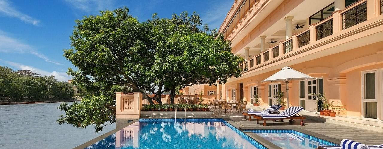 An image of a property featuring three storey building and a swimming pool next to it - Leisure Hotels
