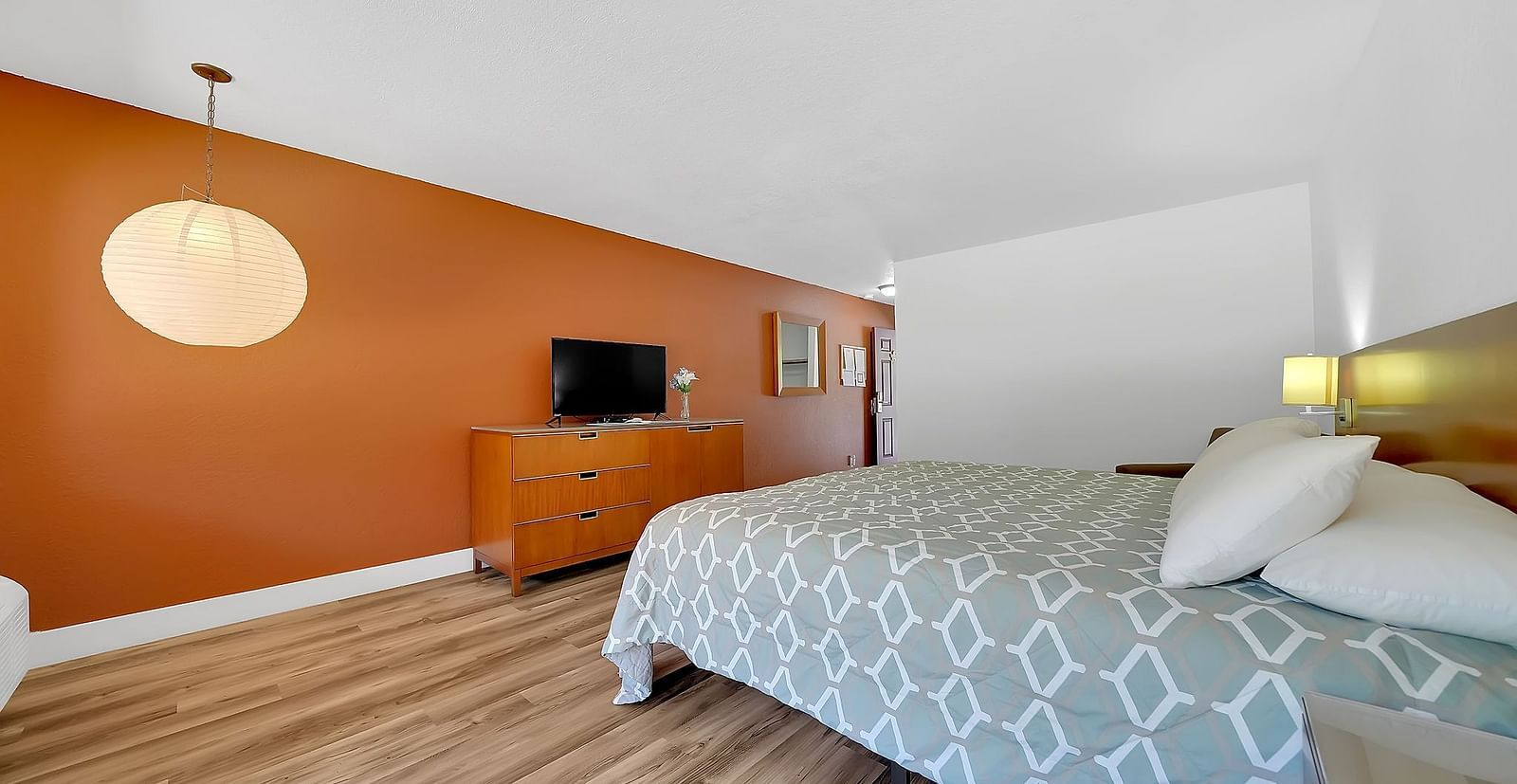 A view of a room at Amador Hotel with a double bed and a television.