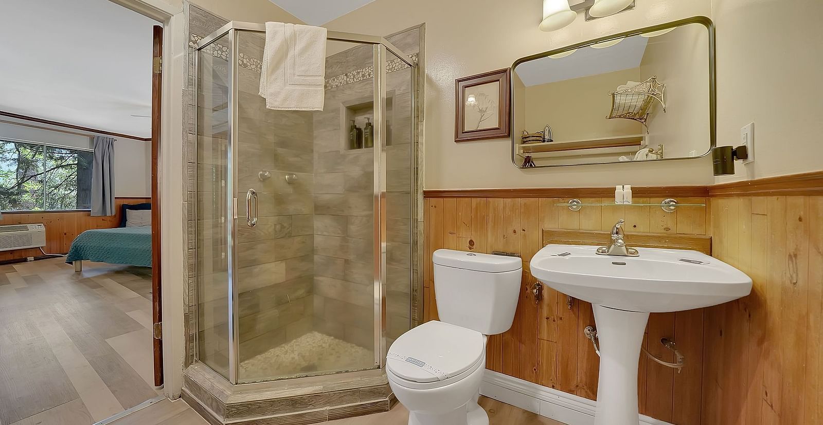 A washroom at Narrow Gauge Inn with a separate shower cubicle and a vanity area.