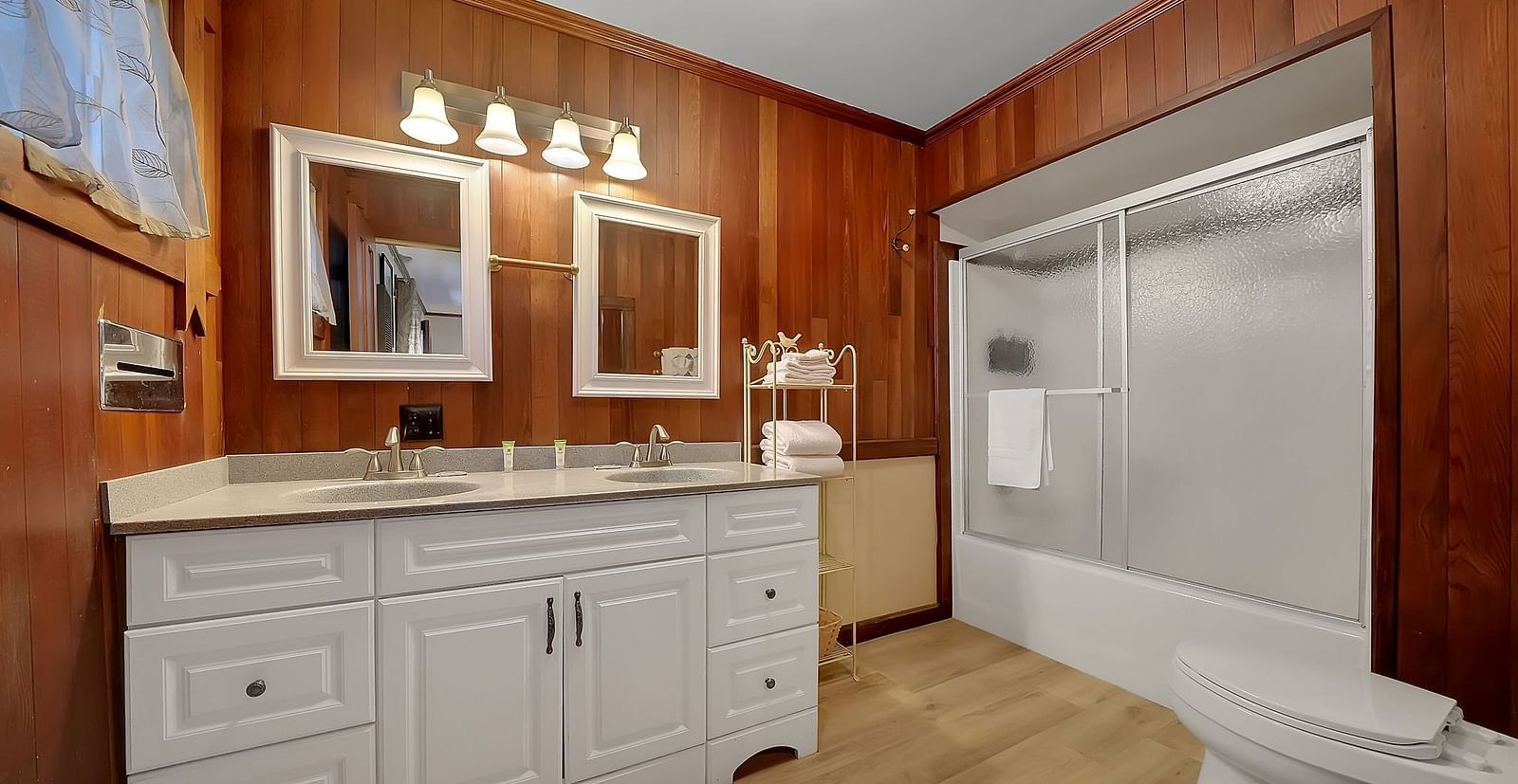 A closet with a well-lit vanity and a large closet - Narrow Gauge Inn - A Serenite Hotel Near Fish Camp.
