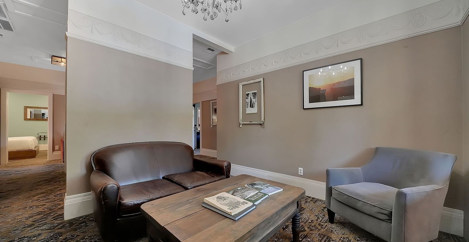 Living room area of a suite at The Groveland Hotel with sofa seating and a coffee table.
