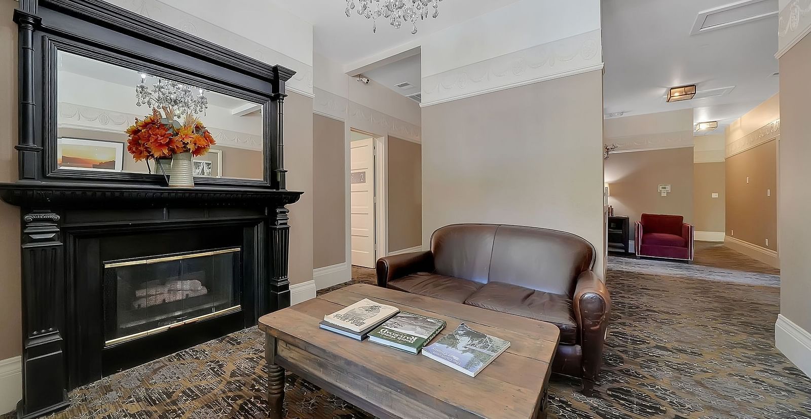 Living room area of a suite at The Groveland Hotel with sofa seating and a coffee table.
