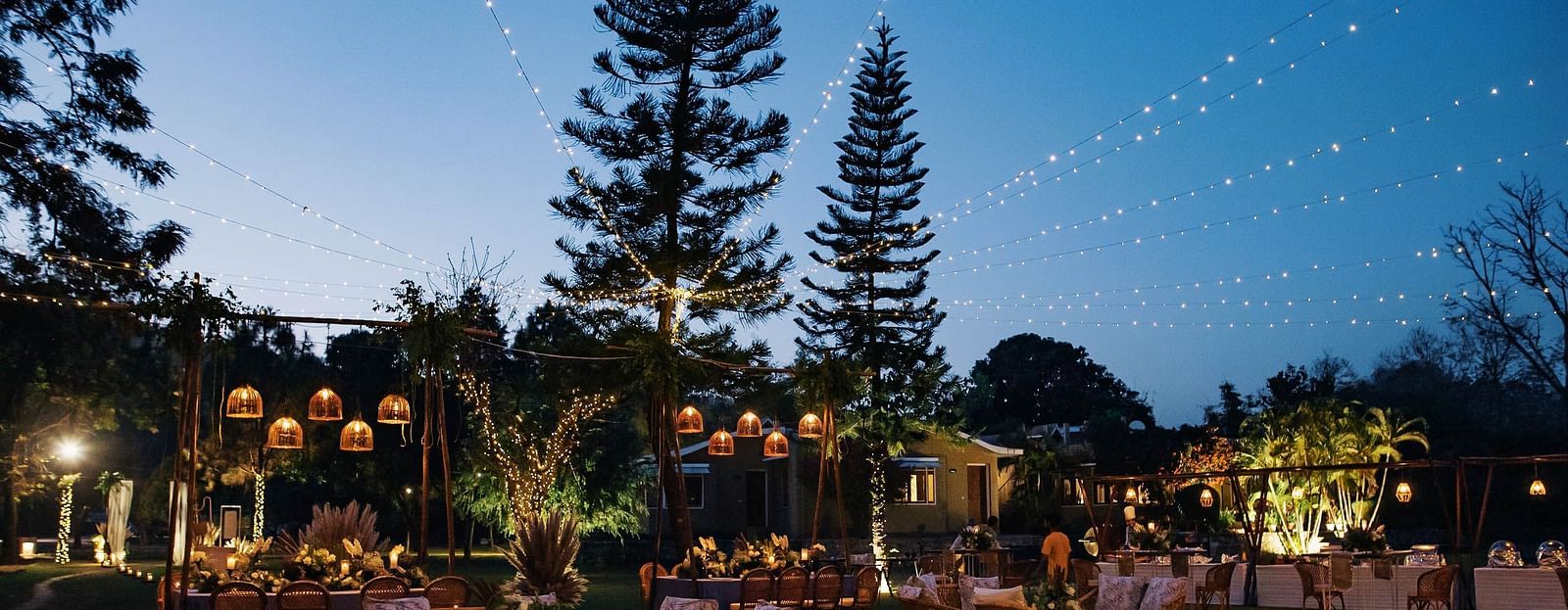 Cozy outdoor seating arrangements with a sunset sky.