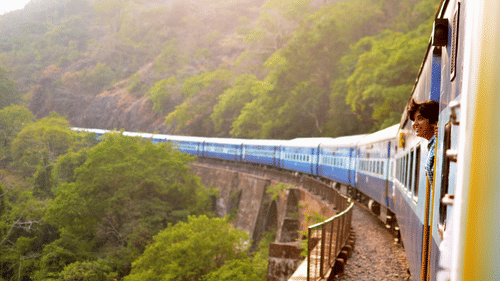an image taken from a Train when it is curving ahead with forest cover on either side