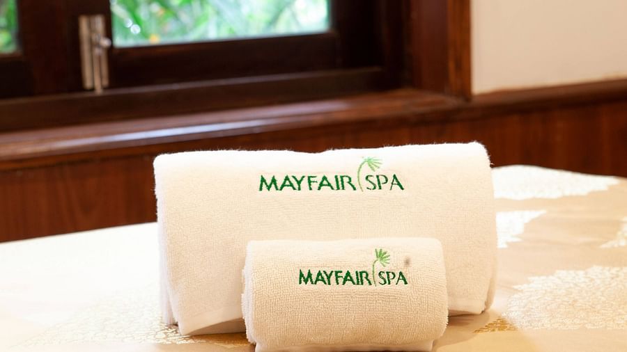 folded towels kept on a spa bed -Mayfair Lake Resort, Raipur
