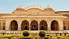 Amber Fort under a clear sky featuring a fountain surrounded by manicured garden