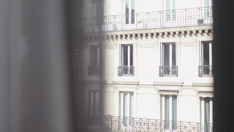 a window shot of a hotel during daytime