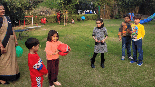 An outdoor scene with several people gathered on a green lawn