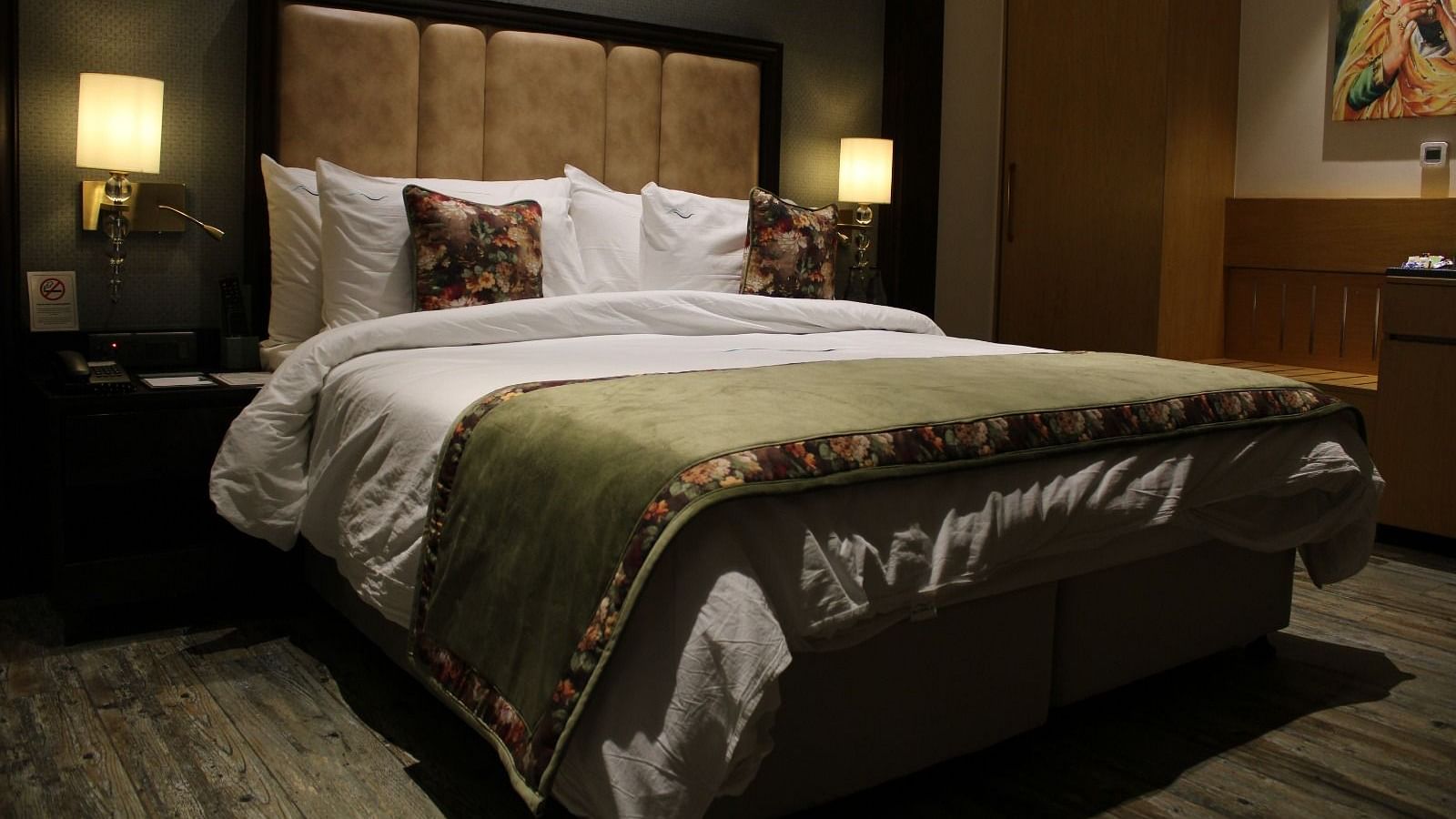 A room with a king size bed, patterned headboard, and lamps at BluSalzz Residence, Amritsar