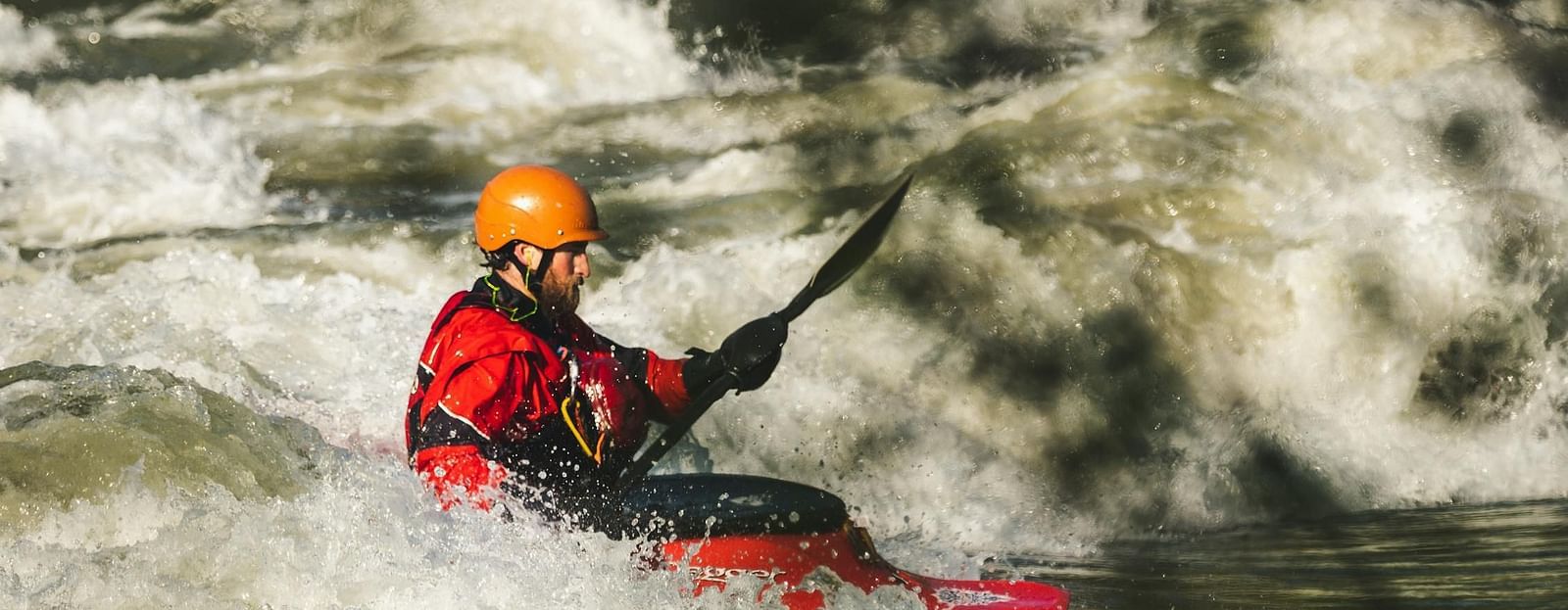 Person kayaking on a river.