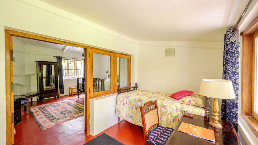 interior view of the Cherry Blossom category at Wallwood Garden - 19th Century, Coonoor showing bedroom connection and wooden partitions.