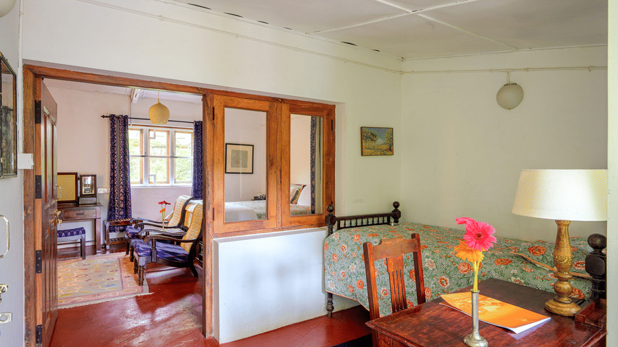 Connecting view of the Silver Oak category at Wallwood Garden - 19th Century, Coonoor with bedroom, seating area and wooden partitions.