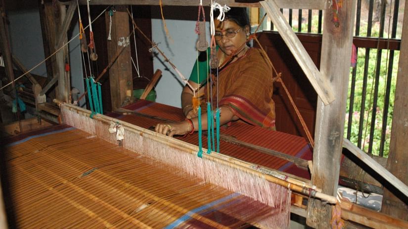 A weaver making sarees in a traditional loom at the weaving centre, near Chidambara Vilas.