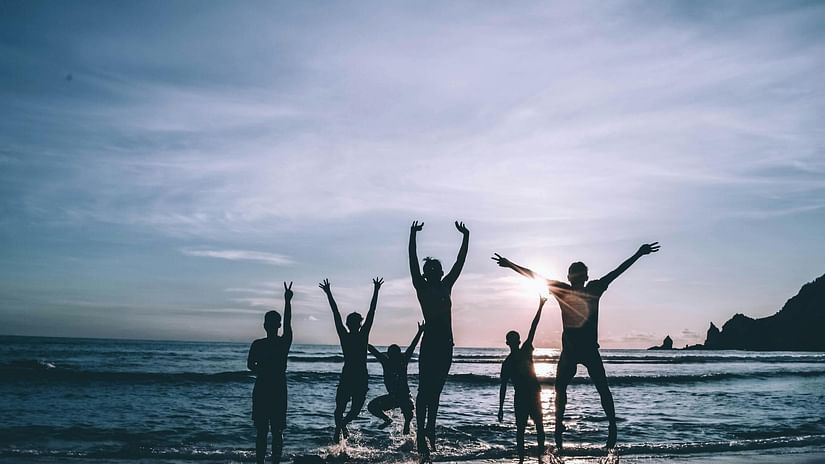 group of men playing at the beach