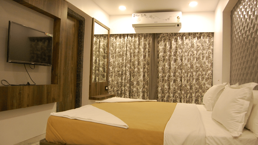 Room at Sanmukh by Adamo showcasing its beautiful interior and wooden furniture.