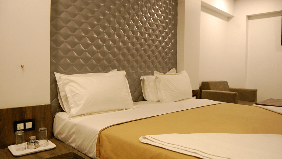 Room at Sanmukh by Adamo showcasing the modern interior and clean ambience with subtle lighting.