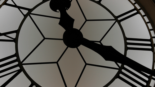 a close up shot of a big clock with an intricate design