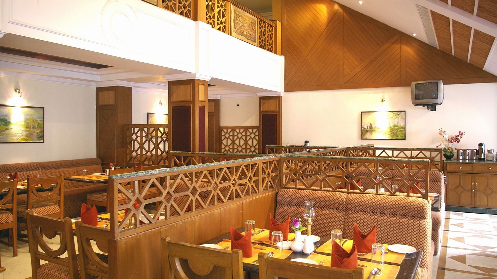 A dining seating of a restaurant at Regency Kanchipuram by GRT Hotels.