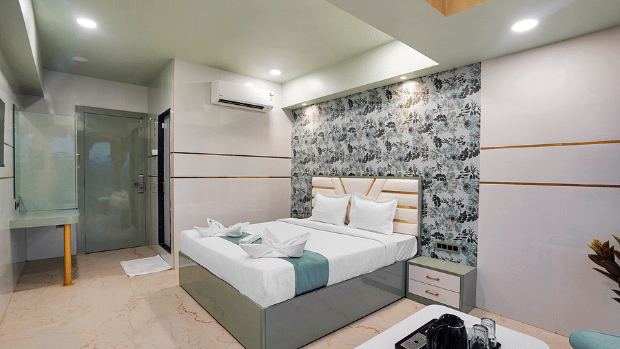A king size bed of Deluxe Room at Hotel Regal Heaven, Pune.