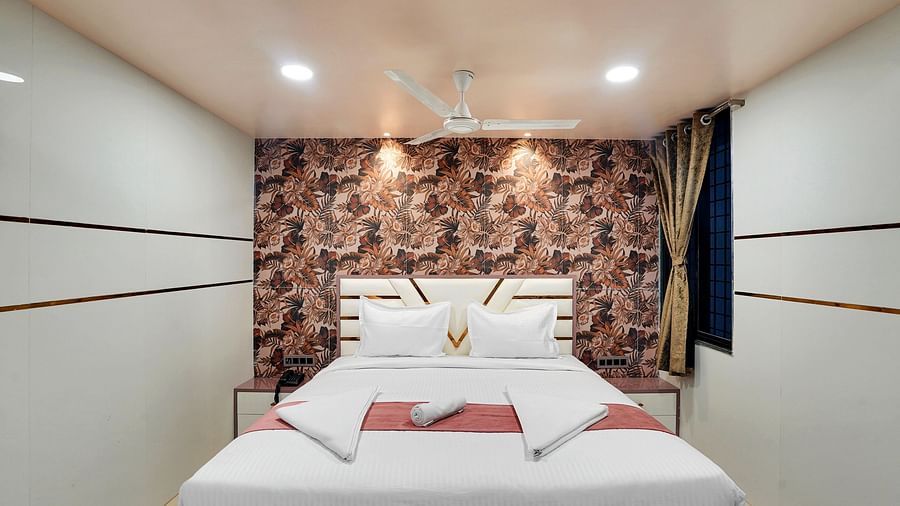 A king size bed in Suite at Hotel Regal Heaven, Pune.
