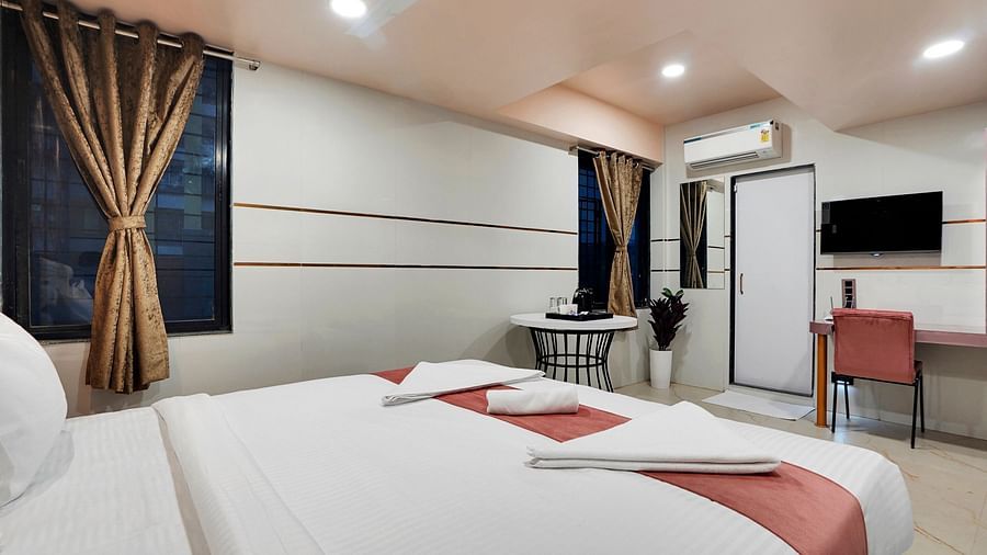 A king size bed in Suite at Hotel Regal Heaven, Pune.