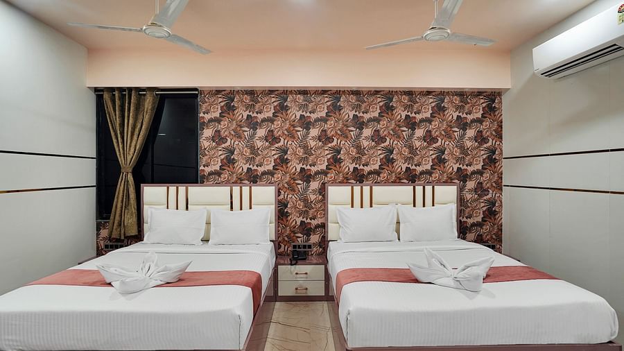 Two king size beds in the Family Room at Hotel Regal Heaven, Pune.