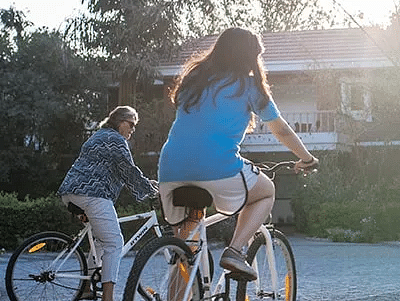 Women riding  bicycles near Karma Chalets.