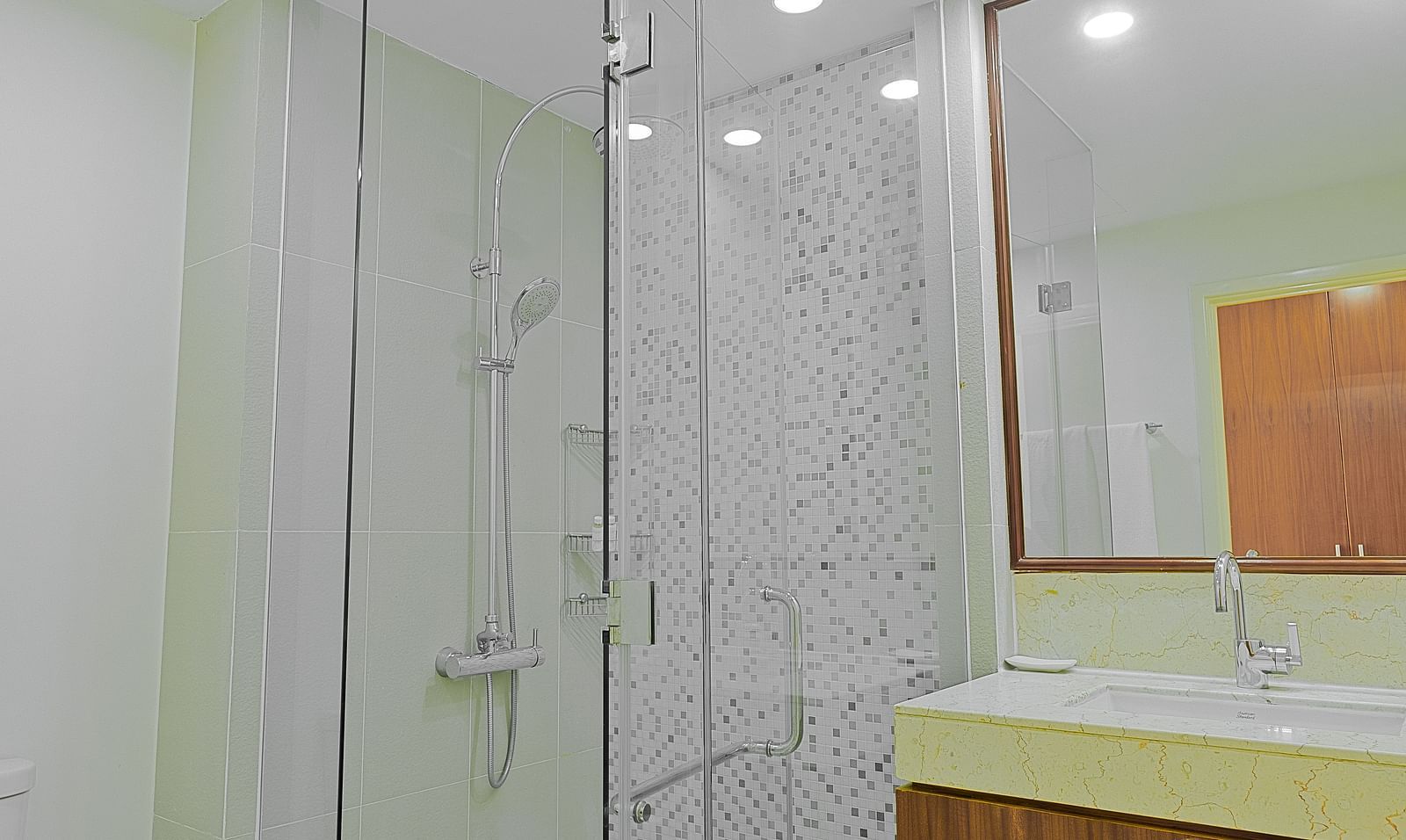 A bathroom with white cabinets, a large mirror, and a sink | Four-bedroom Suite | Central Mansions, Phnom Penh