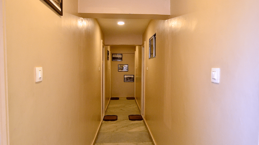A hotel hallway with clear pathways and handrails for easy navigation - BN Tourist Home, Ooty