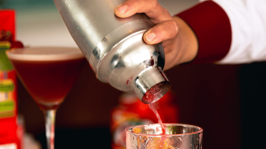 Close up shot of a drink being poured into a glass on a counter at Mandala Norling Lords Prime in Kathmandu.