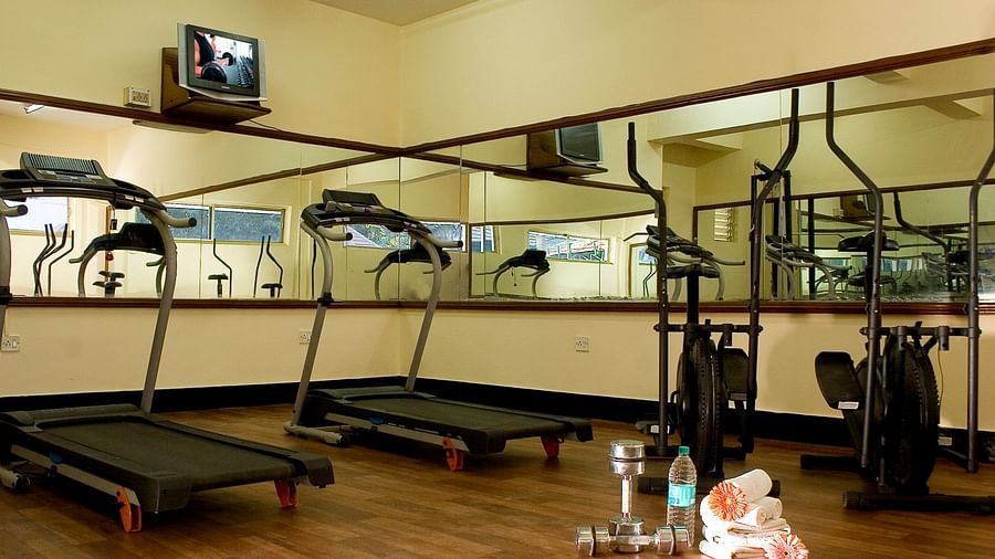 Ramanashree California Resort - interior view of the Gym equipped with treadmill and dumbbells
