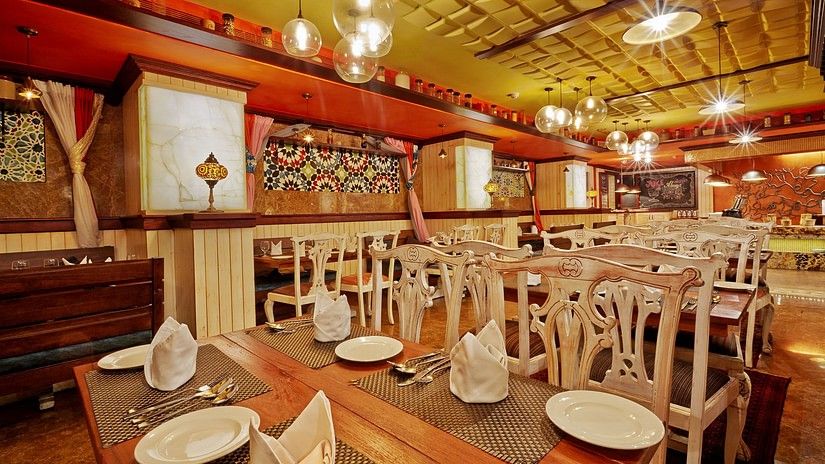 Dining tables with chairs at The Spice, a popular buffet restaurant in Chennai, located at Hablis Hotel.