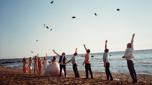 bride, groom, bridesmaids and groomsmen posing for a picture at a beachside wedding in south goa