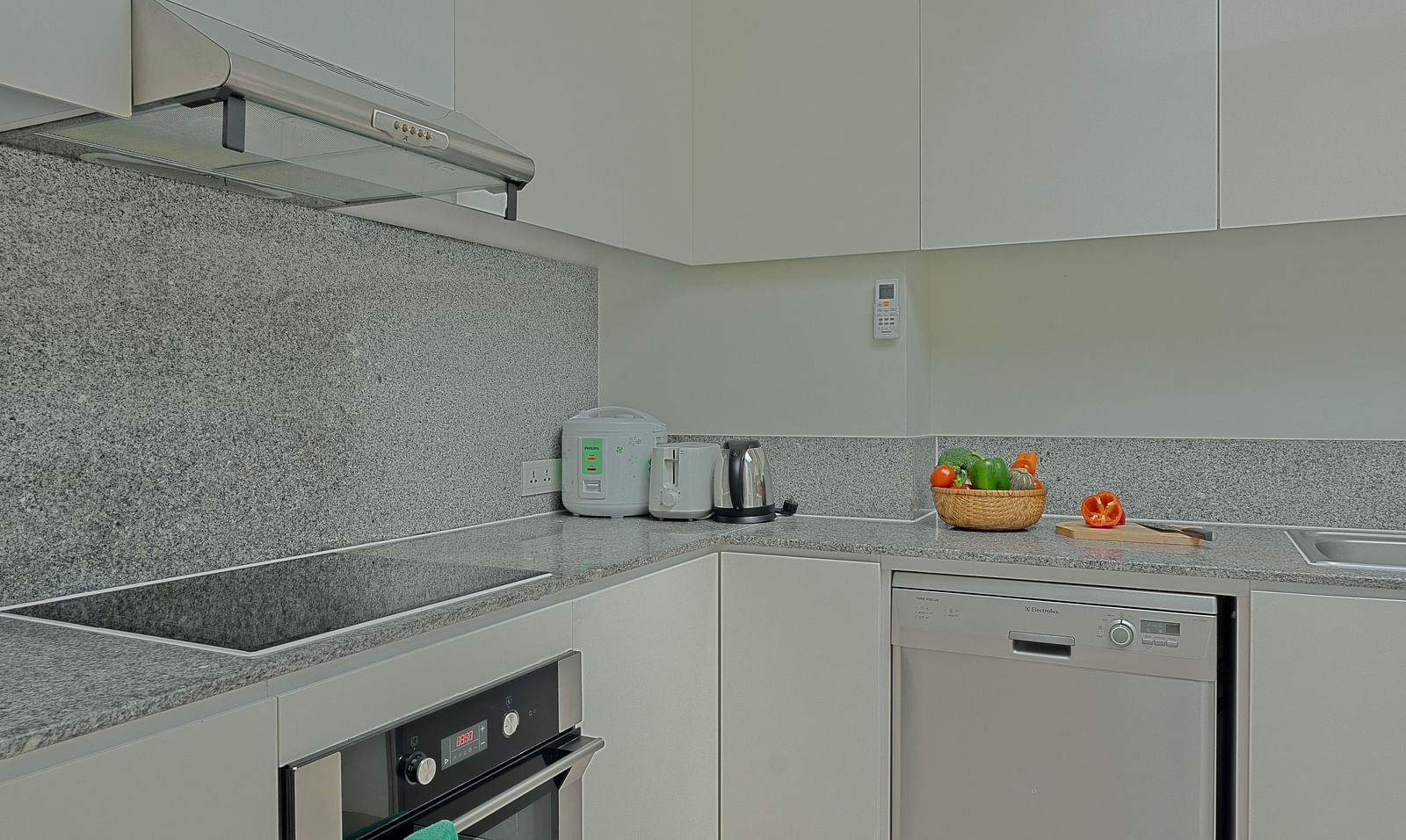 A view of a kitchen with white cabinets, a sink, and a stainless steel stove | Penthouse | Central Mansions, Phnom Penh