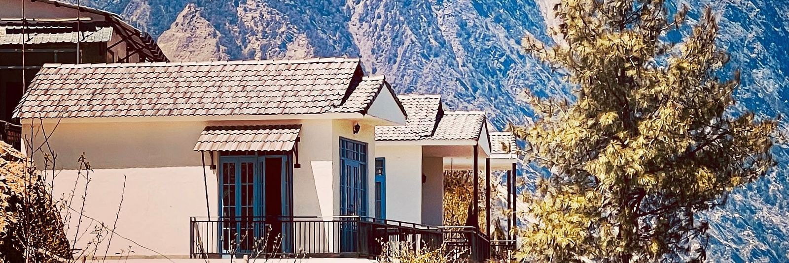 Image of the facade of Faraway Cottages, Auli and mountains in the background | Faraway Cottages, Auli