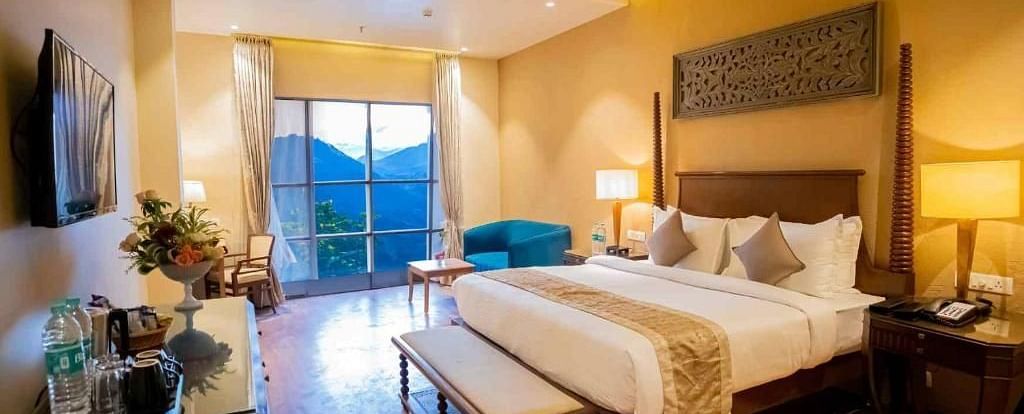 A king size bed placed in front of a TV in a room at Essentia Luxury Resort & Spa, Udaipur.