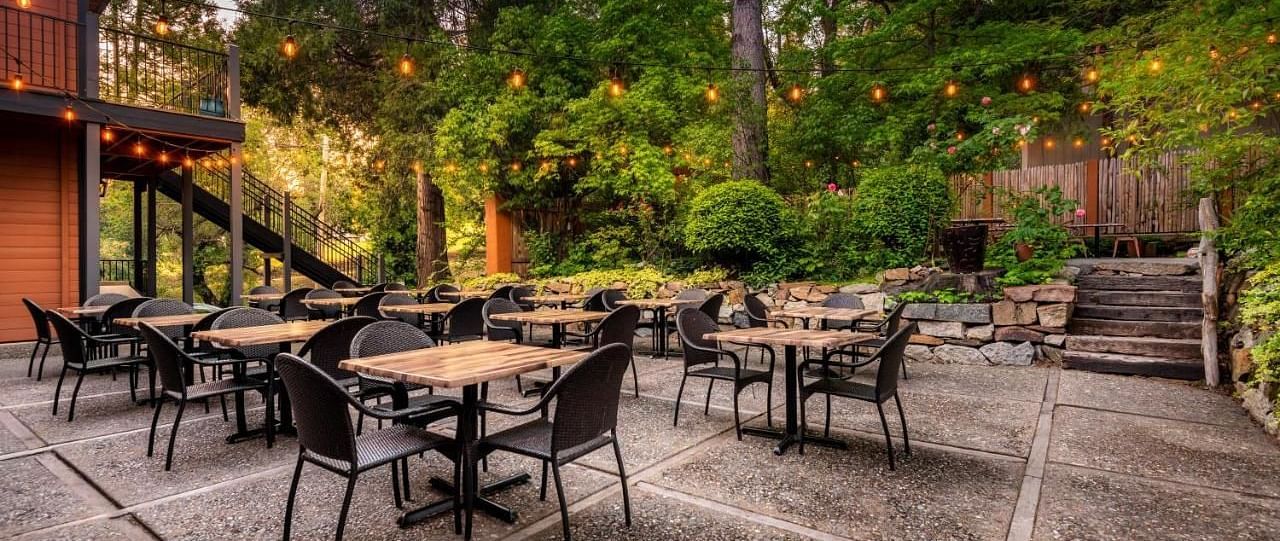 Overview of the outdoor dining arrangement in a backyard at The Groveland Hotel.