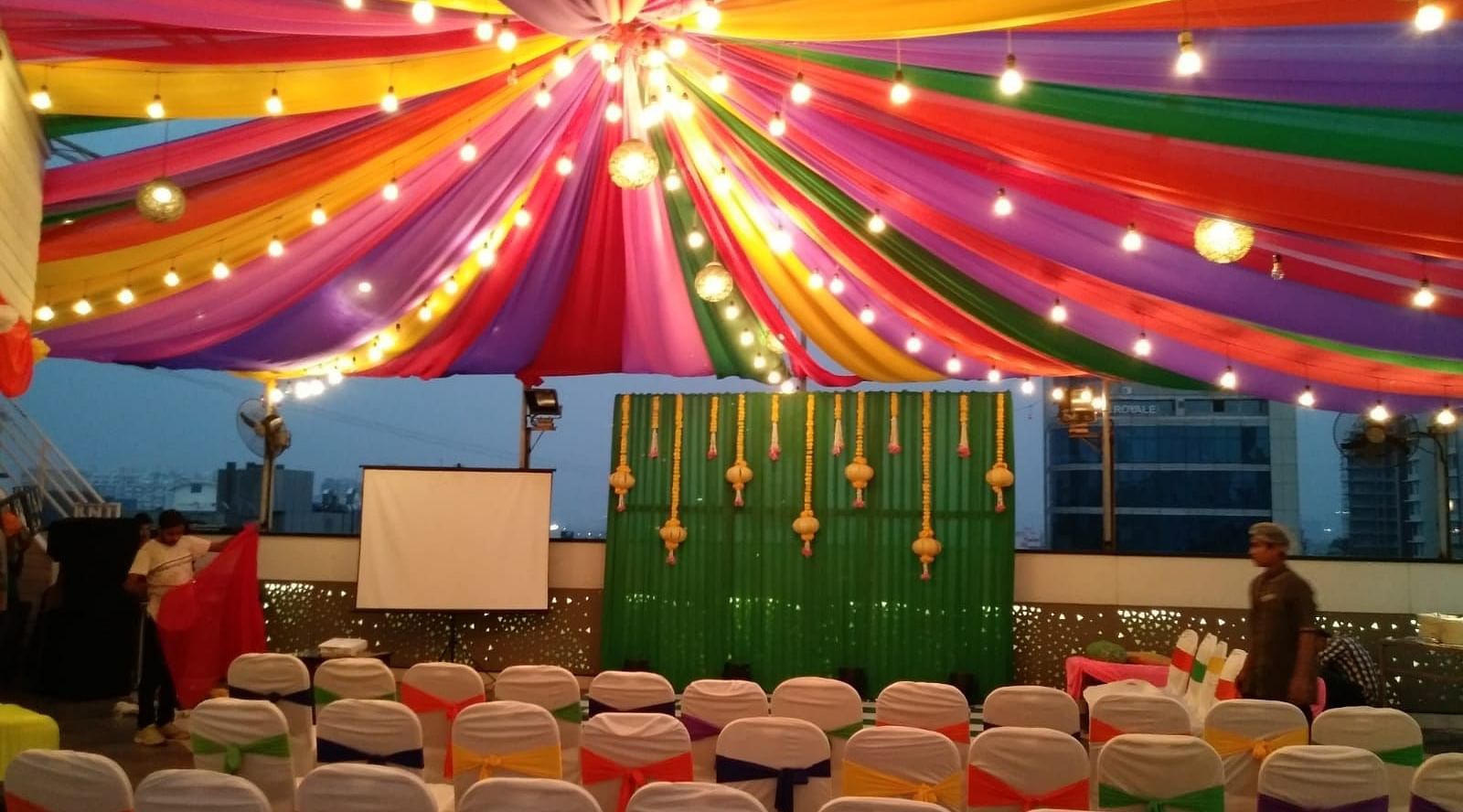 Image of an outdoor event space with chiars and light above at The Oriental Residency