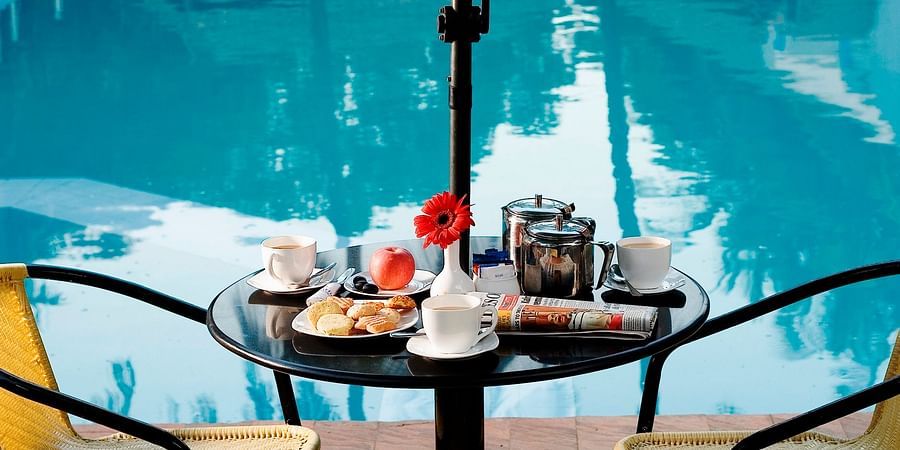 Ramanashree California Resort - view of a coffee table facing the swimming pool