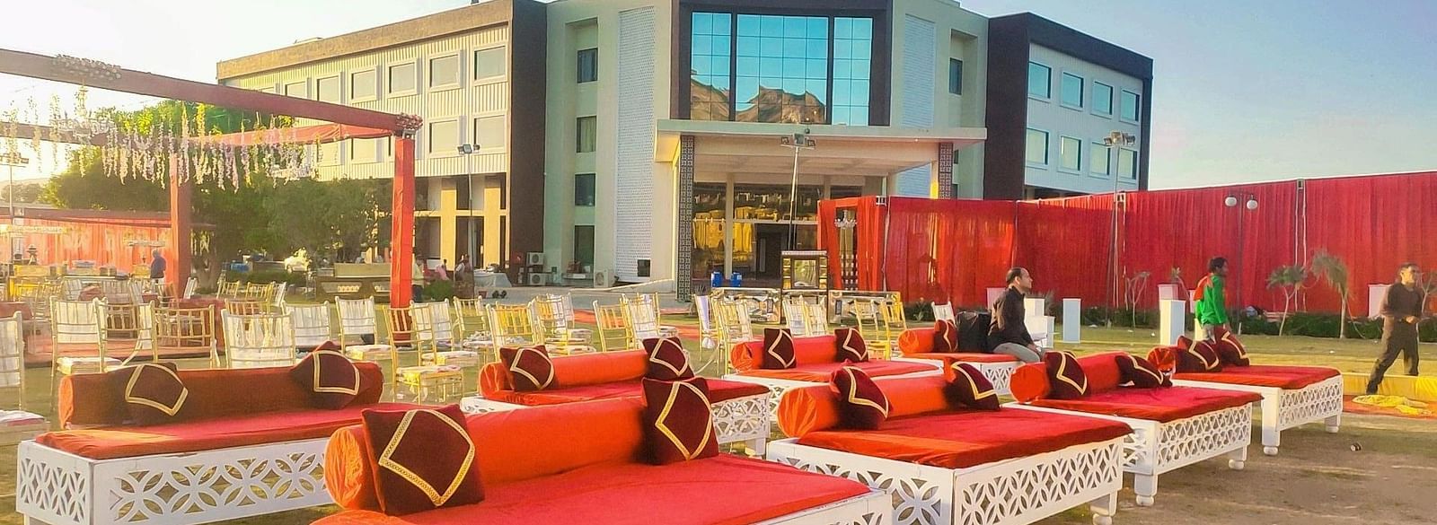 An outdoor event space at the Bamboo Saa Mulberry Resort, Pushkar, set up with decorative seating arrangements.