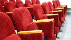 Side view of the red colours chairs in the cinema hall