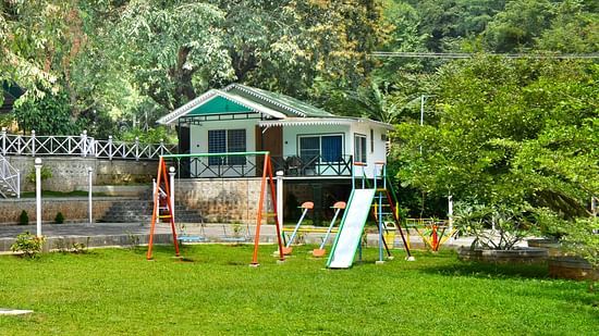 Image of the Play area featuring the swing and slider in the day time.